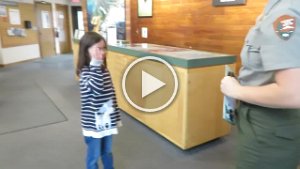 MVI 1595  Megan taking the Junior Ranger Pledge, Kenai Fjords National Park Visitor Center, AK