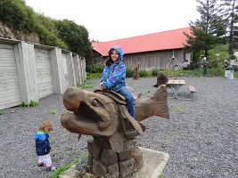 IMG 8304  Megan riding a salmon wood carving, Seldovia, AK