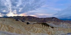 ZabriskiePoint-SunriseClouds-DVNP Panoramic view of the badlands around Zabriskie Point, Death Valley National Park