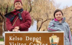 IMG_7710 Winston and Megan in front of the Kelso Depot Visitor Center sign, Mojave National Preserve